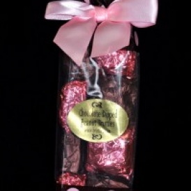 12 Chocolate Dipped Peanut Bruttles wrapped in pink and brown foil and put into a brown with pink polka dots bag with a pink satin bow