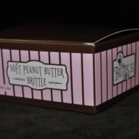8 oz Soft Peanut Butter Brittle in a pink and brown stripped box.