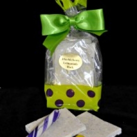 Huckleberry Lemon Bark in a green and clear cello bag with purple polka dots and closed with a green stain bow