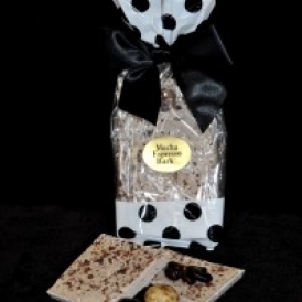 Mocha Espresso Bark in a white and clear cello bag with black polka dots and closed with a black satin bow